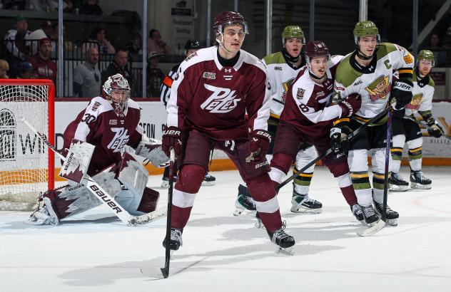 Peterborough Petes defenceman Grayden Strohack (center) and goaltender Easton Rye vs. the North Bay Battalion