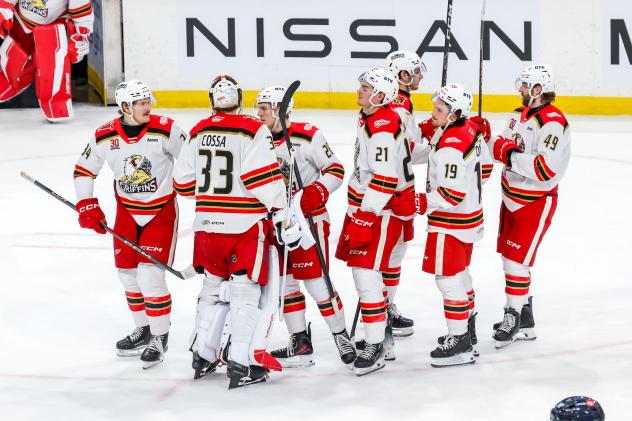 Grand Rapids Griffins exchange congratulations after beating the Manitoba Moose
