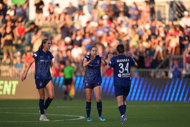 Ashley Sanchez (middle) and Manaka Matsukubo (right) of the North Carolina Courage celebrate after a goal
