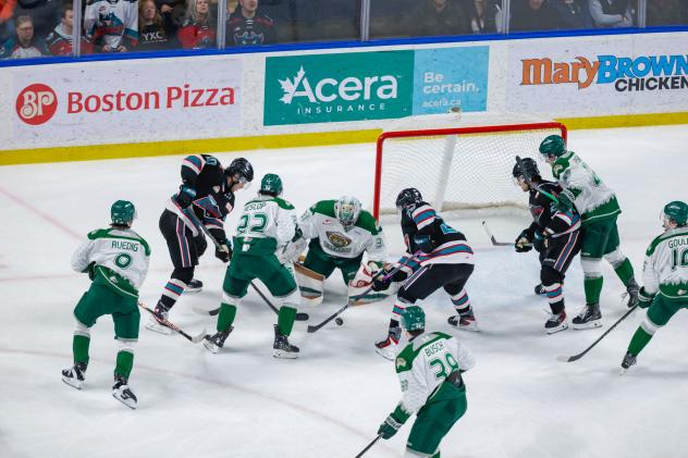Kelowna Rockets fight for the puck in front of the Everett Silvertips net