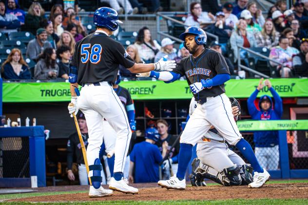 Syracuse Mets exchange congratulations after a home run