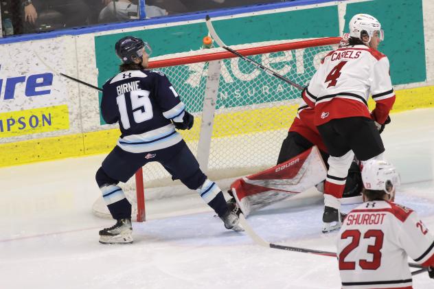 Penticton Vees' Brady Birnie and Prince George Cougars' Carson Carels and Lee Shurgot on the ice
