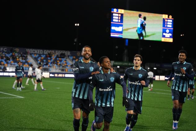 Rhode Island FC all smiles after a goal against the Charleston Battery