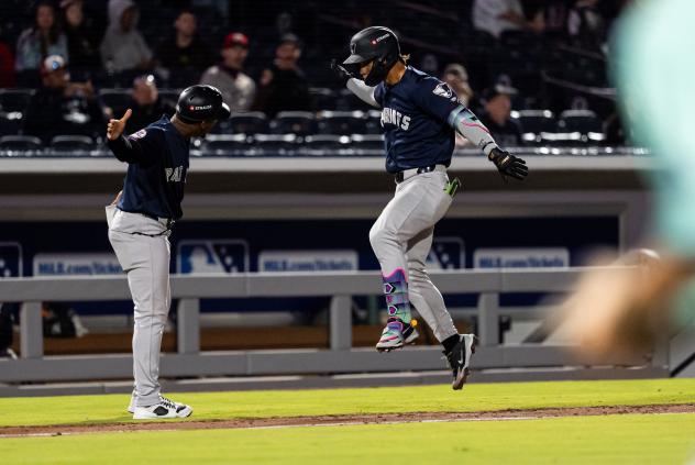 Kenedy Corona of the Somerset Patriots (right) rounds the bases