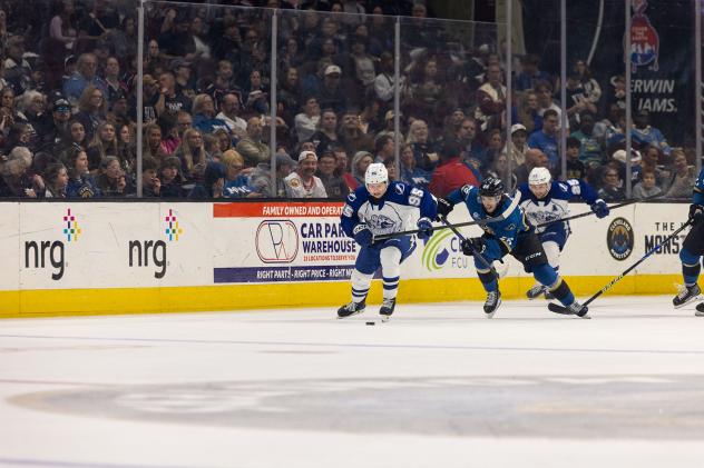 Syracuse Crunch forward Gabriel Szturc (left) eyes the puck against the Cleveland Monsters