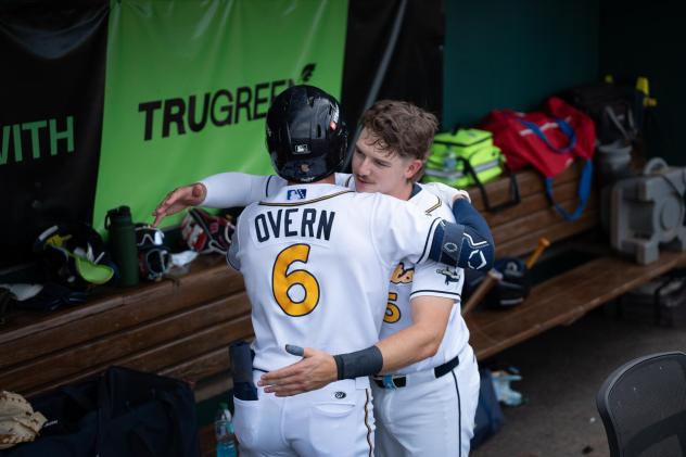 Austin Overn of the Montgomery Biscuits is greeted in the dugout