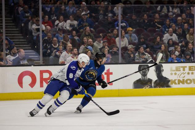 Syracuse Crunch defenseman Tommy Miller (left) vs. the Cleveland Monsters
