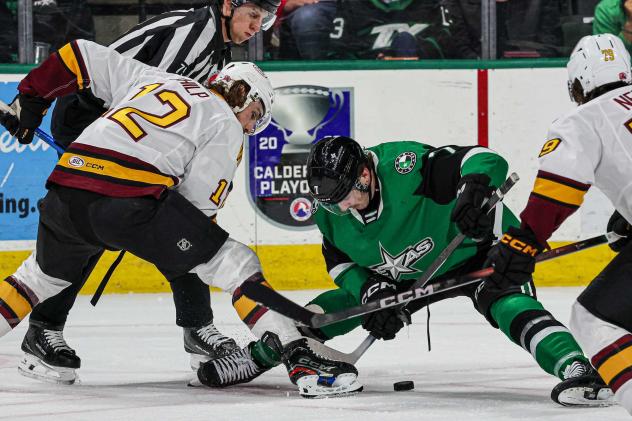 Texas Stars forward Ellis Rickwood (right) faces off with the Chicago Wolves