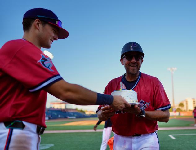 Pensacola Blue Wahoos present Manager Nelson Prada a cake after his 800th victory
