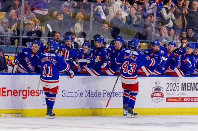 Kitchener Rangers exchange congratulations along the bench