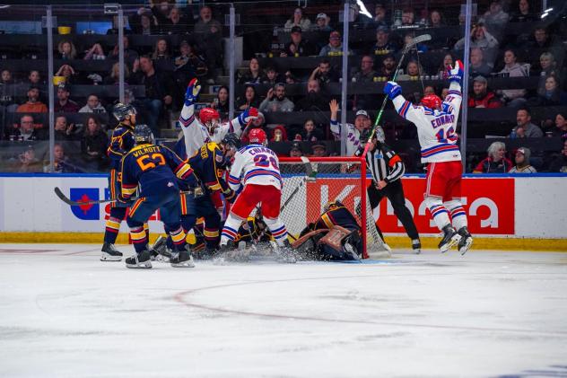 Dylan Edwards of the Kitchener Rangers (far right) reacts after his goal in double overtime