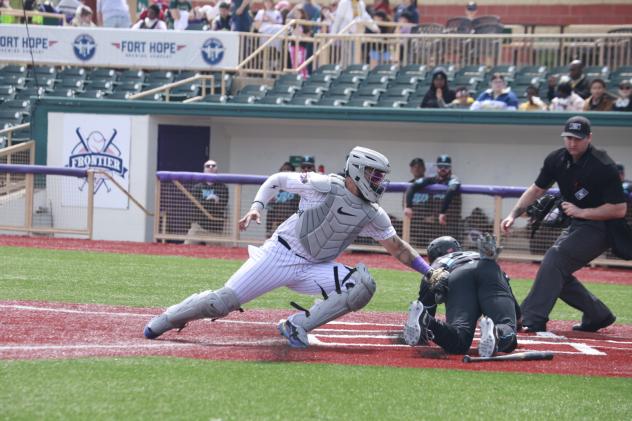 Lake Erie Crushers catcher Derek Vegas makes a tag at home