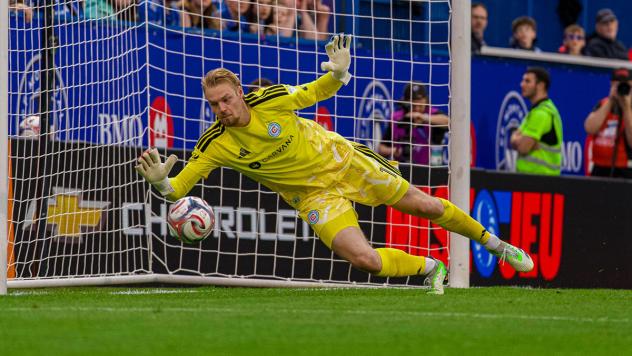Chicago Fire FC goalkeeper Chris Brady prepares to smother a shot