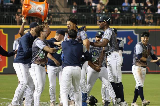 Columbia Fireflies celebrate with Jhosmmel Zue after his game-winning hit