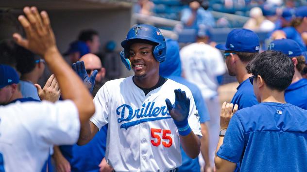 Josue De Paula celebrates in the Tulsa Drillers dugout