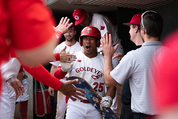 Winnipeg Goldeyes congratulate Noah Marcelo in the dugout