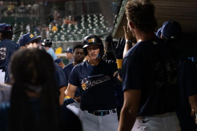 Montgomery Biscuits exchange high fives in the dugout