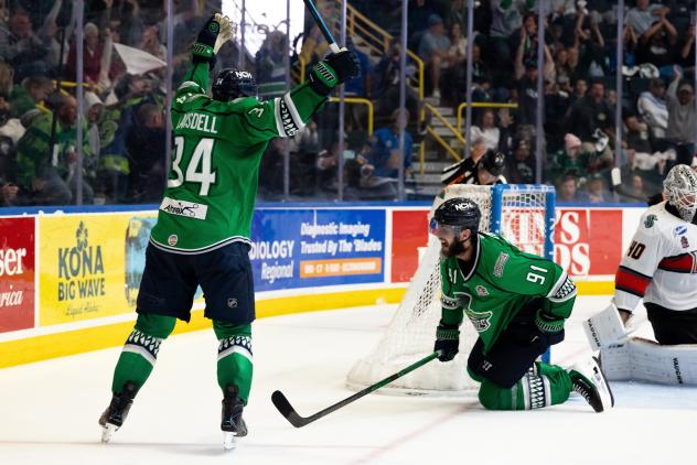 Florida Everblades forwards Hudson Elynuik (right) and Jesse Lansdell celebrate Elynuik's game winner