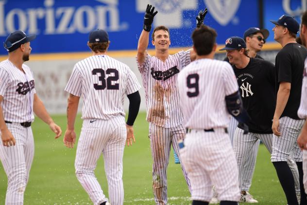 Somerset Patriots celebrate with shortstop Owen Cobb following his game-winning hit