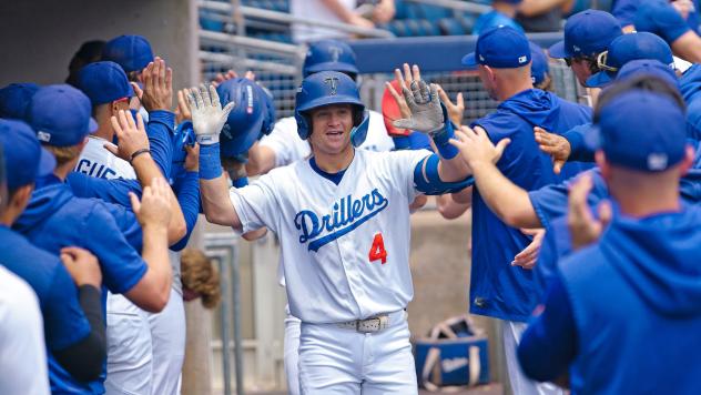 Sean McLain receives congratulations in the Tulsa Drillers dugout