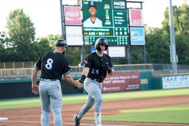 Biloxi Shuckers' coach Matt Lipka congratulates Matthew Wood