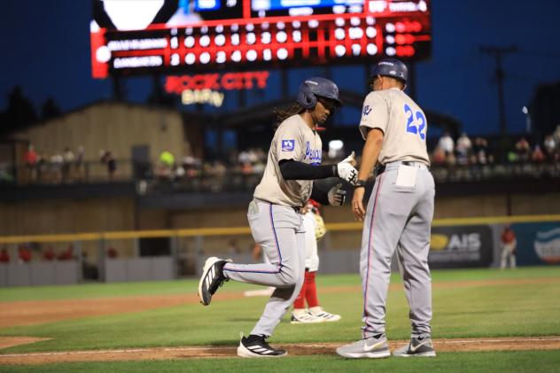 Pensacola Blue Wahoos' Xavier Meachem congratulated by manager Nelson Prada