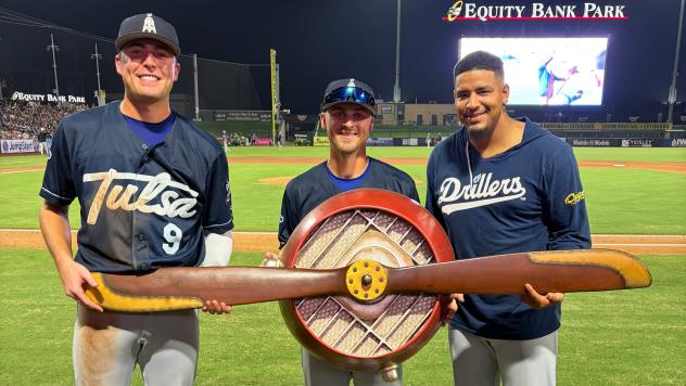 Tulsa Drillers' Chris Newell, Taylor Young, and Christian Suarez holding Propeller Trophy