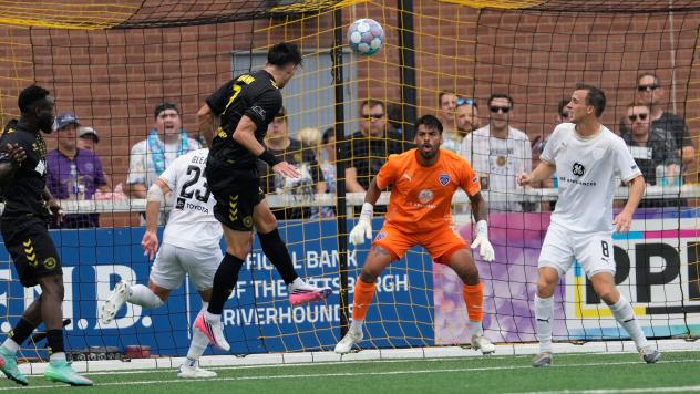 Louisville City FC goalkeeper Danny Faundez awaits a Pittsburgh Riverhounds' header