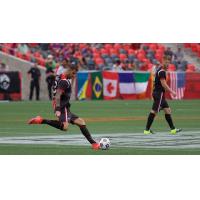 Rafael Alves, kicking, and Richie Ryan of Ottawa Fury FC