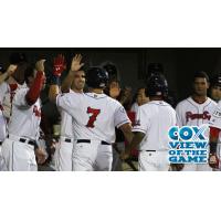 Garin Cecchini of the Pawtucket Red Sox Congratulated in the Dugout