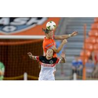 Midfielder Brittany Bock Goes High for a Ball with the Houston Dash