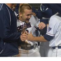of the Somerset Patriots Mobbed by Teammates after Scoring on Wild Pitch