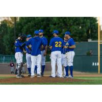 Sioux Falls Canaries Congregate on the Mound