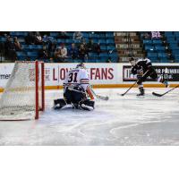 Ty Ronning of the Vancouver Giants Earn scores against Kamloops Blazers Goaltender Dylan Ferguson