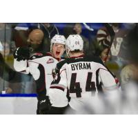 Dylan Plouffe and Bowen Byram of the Vancouver Giants celebrate Plouffe's goal