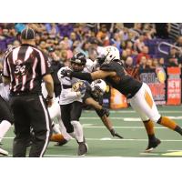 Edward Mosley of the Arizona Rattlers converges on a Cedar Rapids Titan