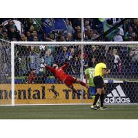Seattle Sounders FC Goalkeeper Stefan Frei makes a diving save on a first-half Montreal Impact free kick