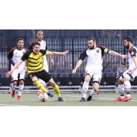 Ottawa Fury FC surround a Pittsburgh Riverhounds player
