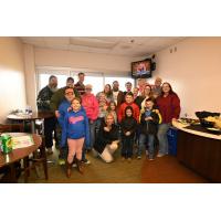A group enjoying a Dragons game from a suite