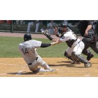 Robert Garcia of the Long Island Ducks beats the tag to complete his game-winning, inside-the-park home run