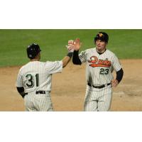 Ramon Cabrera and Travis Snider of the Long Island Ducks exchange high fives