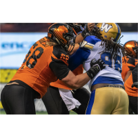 David Foucault of the B.C. Lions protects against the Winnipeg Blue Bombers rush