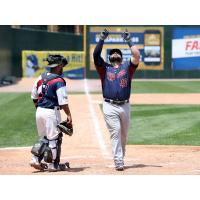 Kyle Roller of the Somerset Patriots points skyward as he crosses home plate