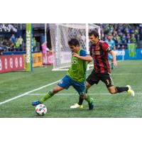 Seattle Sounders FC's Nico Lodeiro and Atlanta United's Michael Parkhurst face off