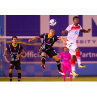Las Vegas Lights FC's Rafael Garcia (center) fights for possession during a 2-0 loss to Phoenix Rising FC