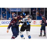 Tulsa Oilers defenseman Mike McKee (left) mixes it up