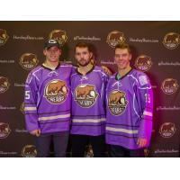 Colby Williams, Riley Barber and Logan Pyett of the Hershey Bears show off the team's Hockey Fights Cancer jerseys