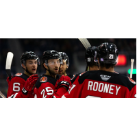 Binghamton Devils exchange congratulations after a goal