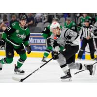 Ryan Olsen of the San Antonio Rampage controls the puck against the Texas Stars' Nicholas Caamano