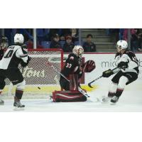 Justin Sourdif of the Vancouver Giants (right) scores against the Prince George Cougars